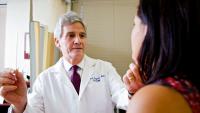 Picture of Dr. Richard Mayeux examining  a patient.
